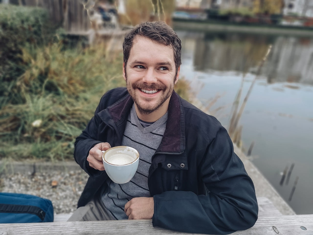 photo of a man with a cup of coffee